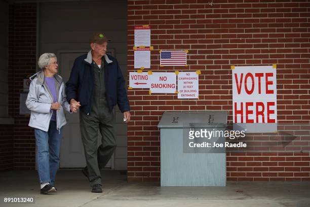 Voters exit after casting their ballots at a polling station setup in the Fire Department on December 12, 2017 in Gallant, Alabama. Alabama voters...