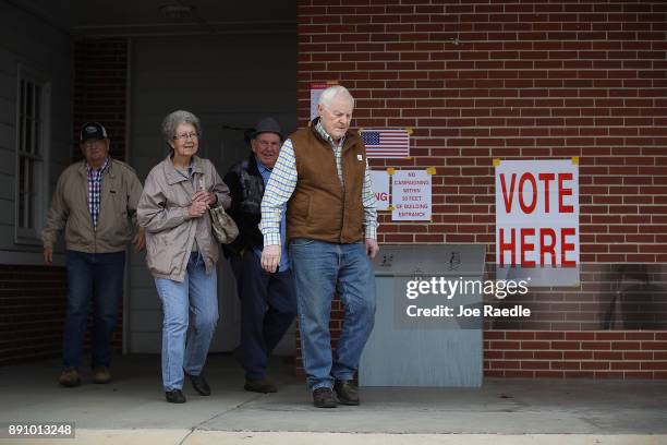 Voters exit after casting their ballots at a polling station setup in the Fire Department on December 12, 2017 in Gallant, Alabama. Alabama voters...