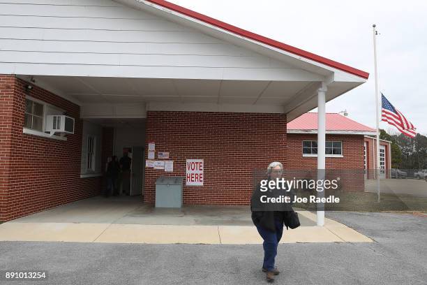 Voter leaves after casting a ballot at a polling station setup in the Fire Department on December 12, 2017 in Gallant, Alabama. Alabama voters are...