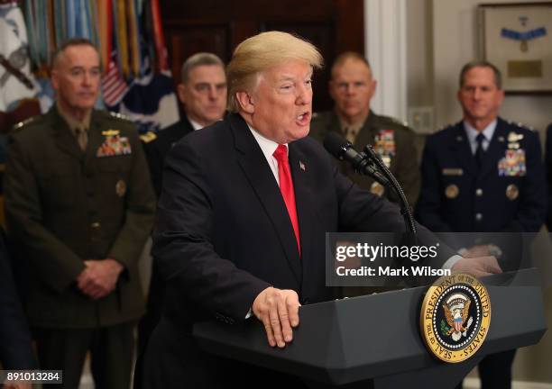 President Donald Trump speaks before signing the H.R. 2810, National Defense Authorization Act for fiscal year 2018, in the Roosevelt Room at the...