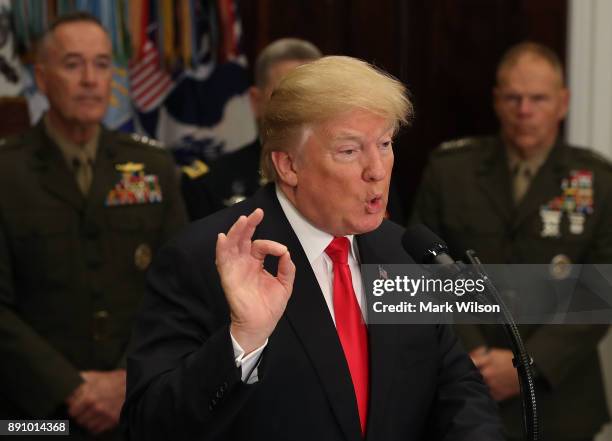 President Donald Trump speaks before signing the H.R. 2810, National Defense Authorization Act for fiscal year 2018, in the Roosevelt Room at the...