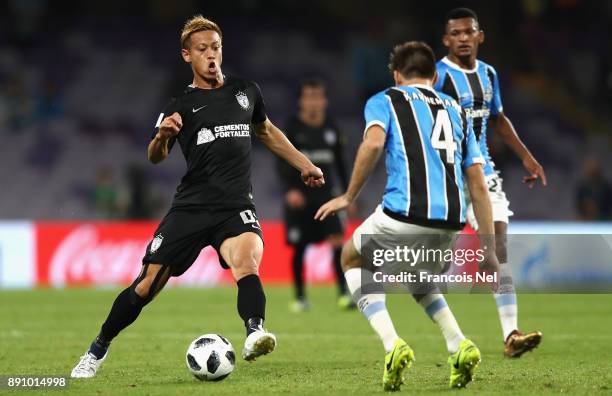 Keisuke Honda of CF Pachuca runs with the ball under pressure from Walter Kannemann of Gremio during the FIFA Club World Cup UAE 2017 semi-final...