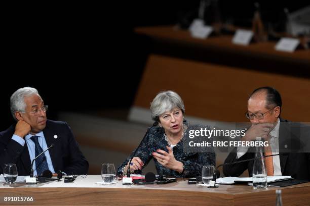 Portugal's Prime minister Antonio Costa, Britain's Prime minister Theresa May and World Bank President Jim Yong Kim take part in a session of the One...