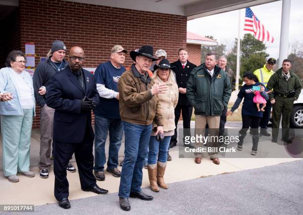 Judge Roy Moore speaks to the media with his wife Kayla at his side after voting at the Gallant Volunteer Fire Department in Gallant, Ala., on...