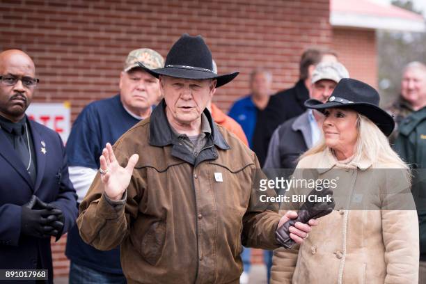 Judge Roy Moore speaks to the media with his wife Kayla at his side after voting at the Gallant Volunteer Fire Department in Gallant, Ala., on...
