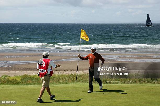 Northern Irish golfer Graeme McDowell holds the pole on the 4th green, on the final day of the 138th British Open Championship at Turnberry Golf...