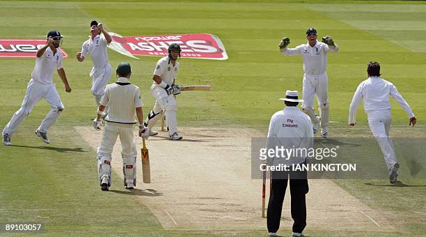 England's Paul Collingwood celebrates catching out Australia's Michael Hussey for 27 runs bowled by England's Graeme Swann during the Australian...