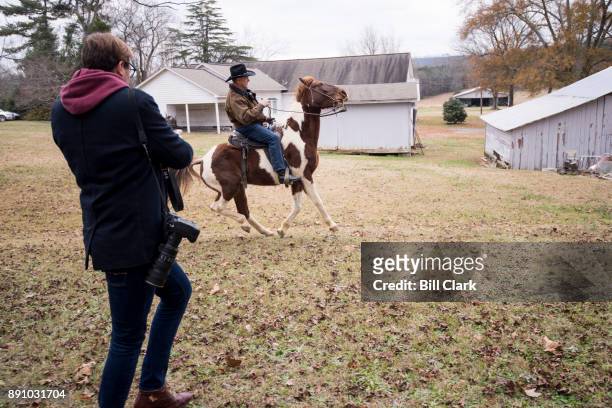 Judge Roy Moore rides away on his horse after voting at the Gallant Volunteer Fire Department in Gallant, Ala., on Tuesday, Dec. 12, 2017.