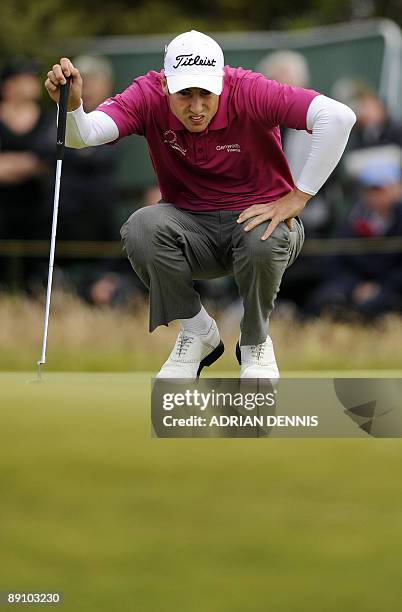 English golfer Ross Fisher lines up his birdie putt on the 1st green, on the final day of the 138th British Open Championship at Turnberry Golf...