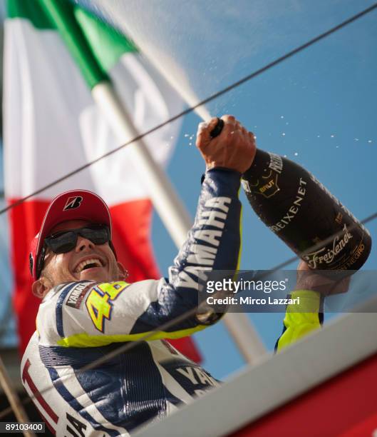Valentino Rossi of Italy and Fiat Yamaha Team celebrates his victory and sprays champagne on the podium after the MotoGp race of the German MotoGP on...