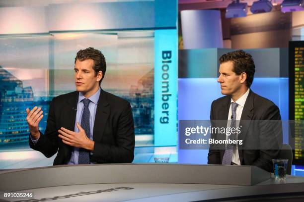 Tyler Winklevoss, chief executive officer and co-founder of Gemini, left, speaks as Cameron Winklevoss, president and co-founder of Gemini, listens...