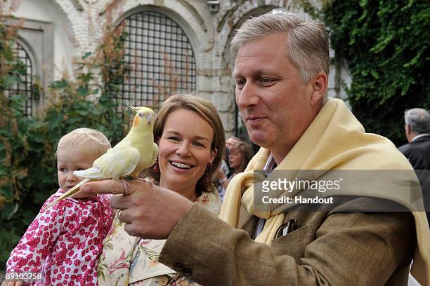In this handout photo, provided by the Belgian Royal Palace, Princess Eleonore, Princess Mathilde and Prince Philippe of Belgium attend a Summer...