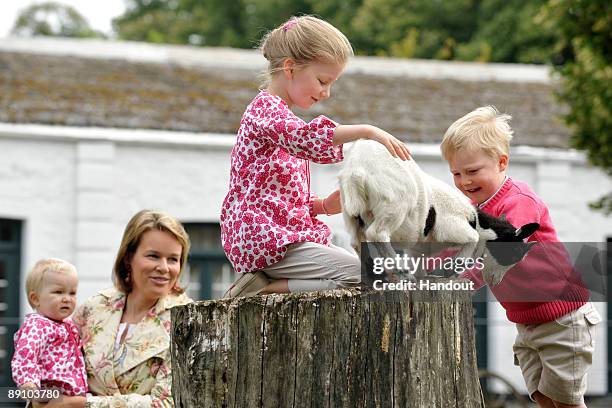 In this handout photo, provided by the Belgian Royal Palace, Princess Elizabeth of Belgium feeds a baby goat as she attends a Summer Photocall at...