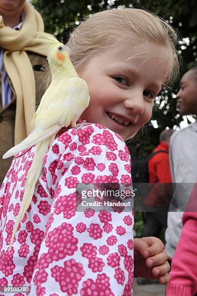 In this handout photo, provided by the Belgian Royal Palace, Princess Elizabeth of Belgium holds a parrot as she attends a Summer Photocall at...
