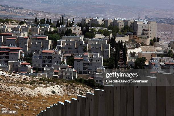 Israel's controversial West Bank barrier seperates the Jewish neighbourhood of Pisgat Zeev from the Palestinian refugee camp of Shuafat July 19, 2009...