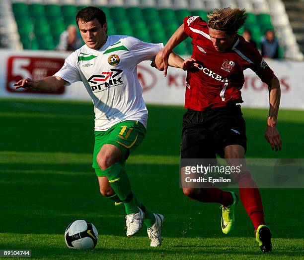 Dmitri Tarasov of FC Moscow battles for the ball with Alan Kasaev of FC Kuban Krasnodar during the Russian Football League Championship match between...