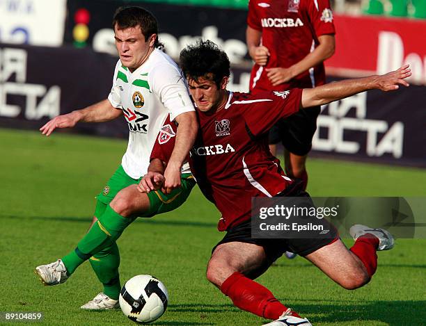 Gia Grigalava of FC Moscow battles for the ball with Alan Kasaev of FC Kuban Krasnodar during the Russian Football League Championship match between...