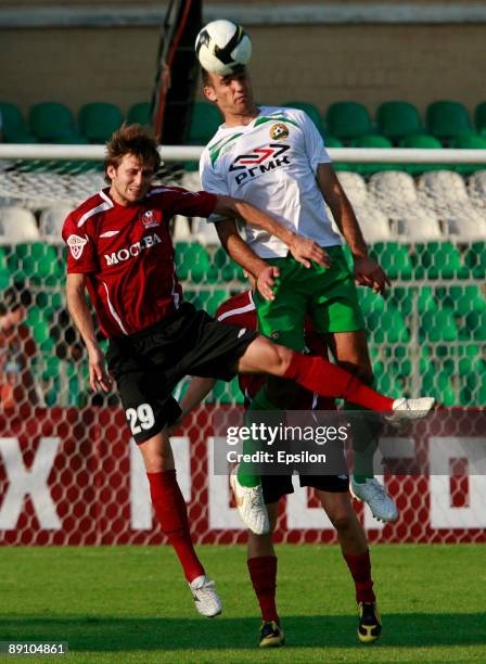 Igor Strelkov of FC Moscow battles for the ball with Georgi Dzhioyev of FC Kuban Krasnodar during the Russian Football League Championship match...