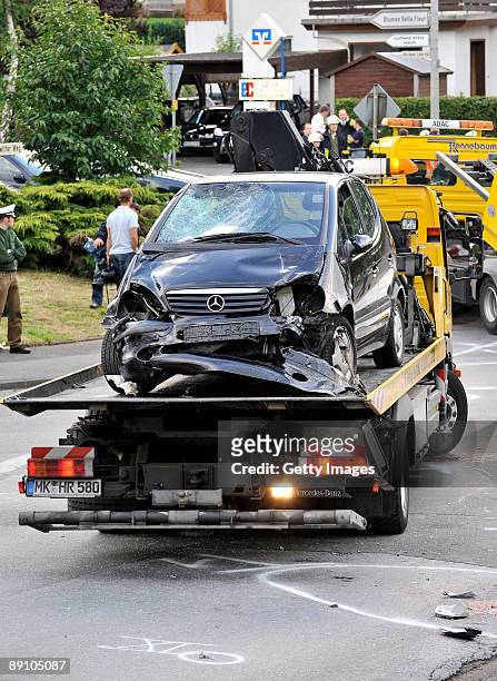Accident damaged cars are recovered on July 19, 2009 in Menden near Arnsberg, Germany. A car rammed a parade in the German town of Menden on Sunday,...