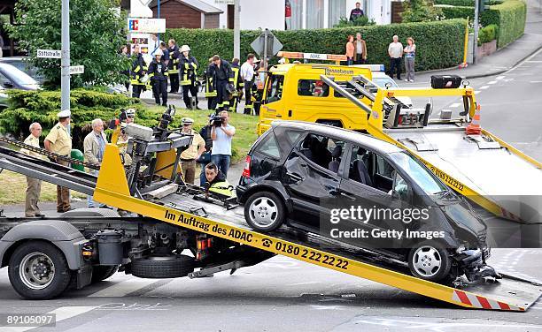 Accident damaged cars are recovered on July 19, 2009 in Menden near Arnsberg, Germany. A car rammed a parade in the German town of Menden on Sunday,...