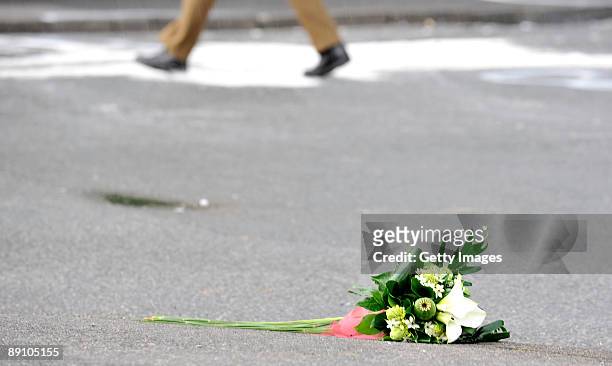 Mourner has laid down flowers during accident clearance on July 19, 2009 in Menden near Arnsberg, Germany. A car rammed a parade in the German town...