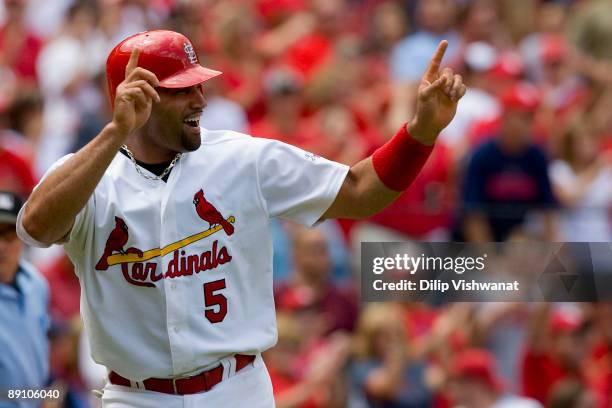 Albert Pujols of the St. Louis Cardinals congratulates teammate Joel Pinero's two RBI double against the Arizona Diamondbacks on July 19, 2009 at...