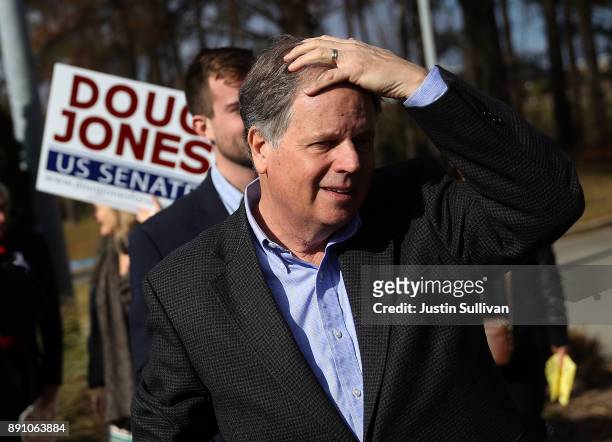 Democratic senatorial candidate Doug Jones prepares to greet voters outside of a polling station at the Bessemer Civic Center on December 12, 2017 in...