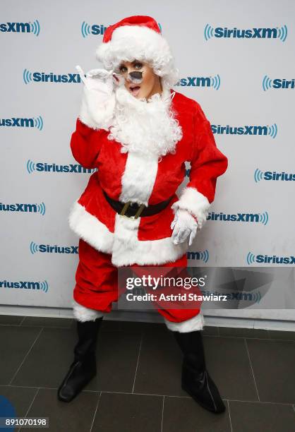 SiriusXM host Jenny McCarthy poses for photos in a Santa costume at the SiriusXM studios on December 12, 2017 in New York City.