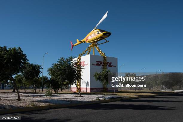 Scultpure of a DHL Worldwide Express helicopter lifting a package stands on display at the Queretaro Intercontinental Airport in Queretaro, Mexico,...