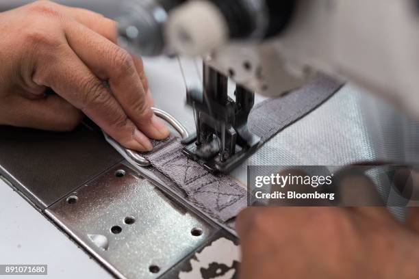 Worker sews straps together while assembling aircraft cargo nets at the Tighitco Inc. Manufacturing facility in San Luis Potosi, Mexico, on Thursday,...