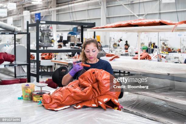 Worker secures the seams of an aircraft insulation blanket at the Tighitco Inc. Manufacturing facility in San Luis Potosi, Mexico, on Thursday, Nov....