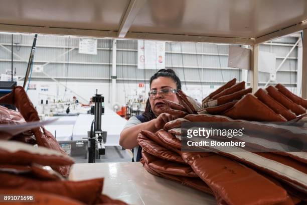 Worker stacks aircraft insulation blankets at the Tighitco Inc. Manufacturing facility in San Luis Potosi, Mexico, on Thursday, Nov. 16, 2017. With...