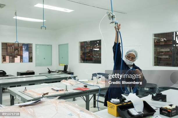 Worker prepares to vacuum pack aircraft parts at the Tighitco Inc. Manufacturing facility in San Luis Potosi, Mexico, on Thursday, Nov. 16, 2017....