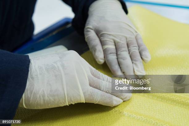 Worker shapes kavlar fabric at the Tighitco Inc. Manufacturing facility in San Luis Potosi, Mexico, on Thursday, Nov. 16, 2017. With 312 registered...