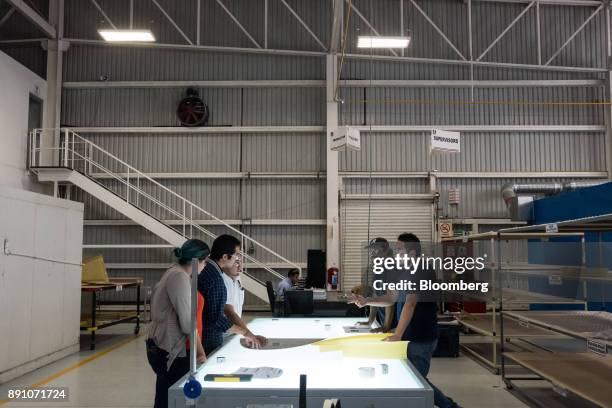 Workers gather for a meeting at the Tighitco Inc. Manufacturing facility in San Luis Potosi, Mexico, on Thursday, Nov. 16, 2017. With 312 registered...