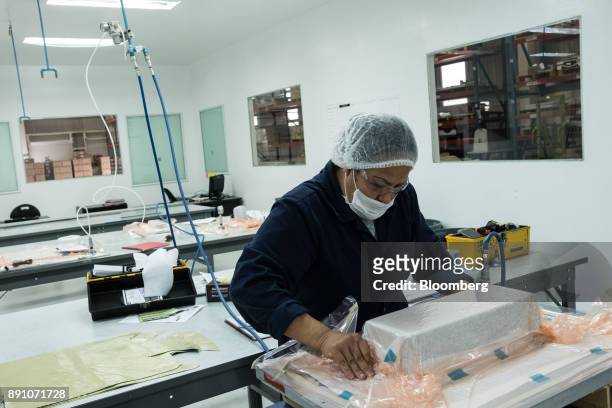 Worker vacuum packs an aircraft part at the Tighitco Inc. Manufacturing facility in San Luis Potosi, Mexico, on Thursday, Nov. 16, 2017. With 312...