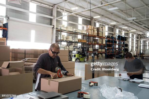 Workers package aircraft components for shipment at the Tighitco Inc. Manufacturing facility in San Luis Potosi, Mexico, on Thursday, Nov. 16, 2017....