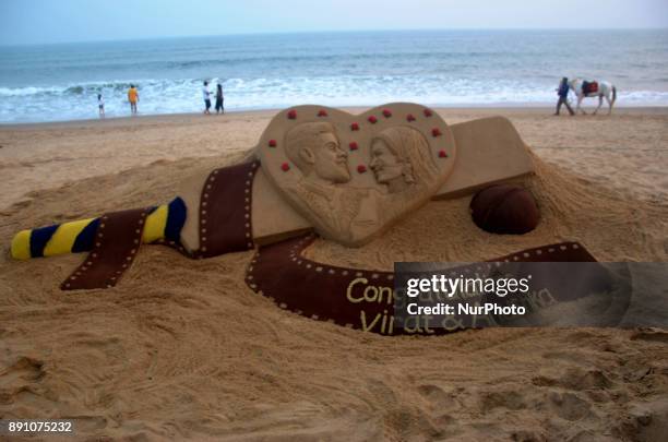 Sand art is seen about the Indian cricket team captain Virat Kohali and Bollywood atress Anuska Sharma's marriage at the Bay of Bengal Sea's eastern...