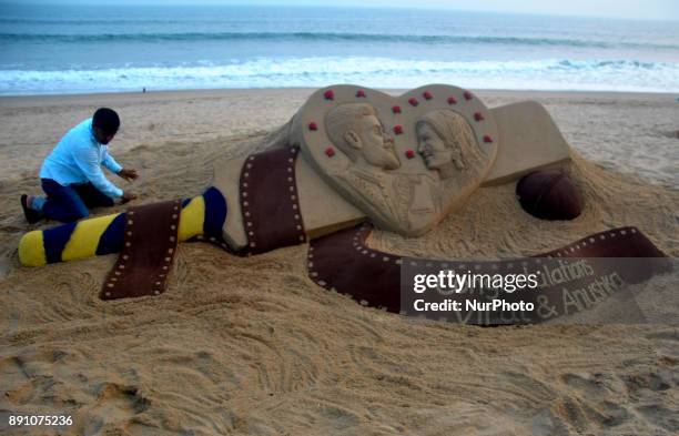 Sand art is seen about the Indian cricket team captain Virat Kohali and Bollywood atress Anuska Sharma's marriage at the Bay of Bengal Sea's eastern...