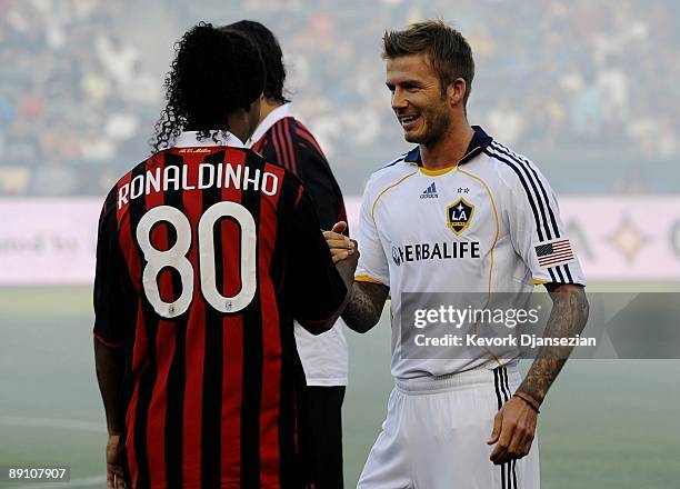 David Beckham of the Los Angeles Galaxy greets former teammate Ronaldinho of AC Milan before the MLS friendly match at The Home Depot Center on July...