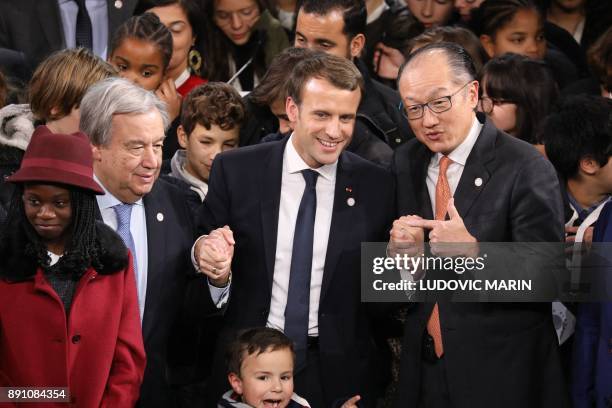 United Nations Secretary General Antonio Guterres , French President Emmanuel Macron and World Bank President Jim Yong Kim pose at the end of a...