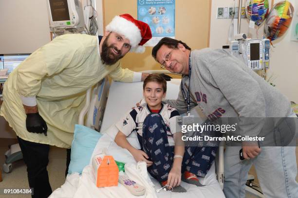 New England Patriot alumni Sebastian Vollmer visits with Mike and Dad at Boston Children's Hospital December 12, 2017 in Boston, Massachusetts.