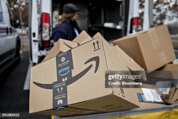 An Amazon.com Inc. Package sits in a bin before being placed on a delivery vehicle at the United States Postal Service Joseph Curseen Jr. And Thomas...