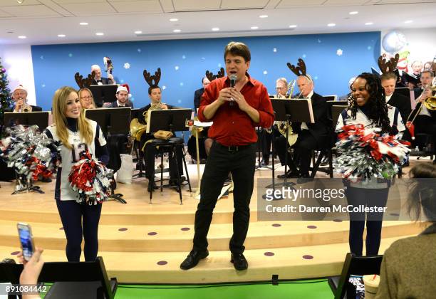 Boston Pops conductor Keith Lockhart with New England Patriots cheerleaders at the Boston Pops Holiday Concert at Boston Children's Hospital December...