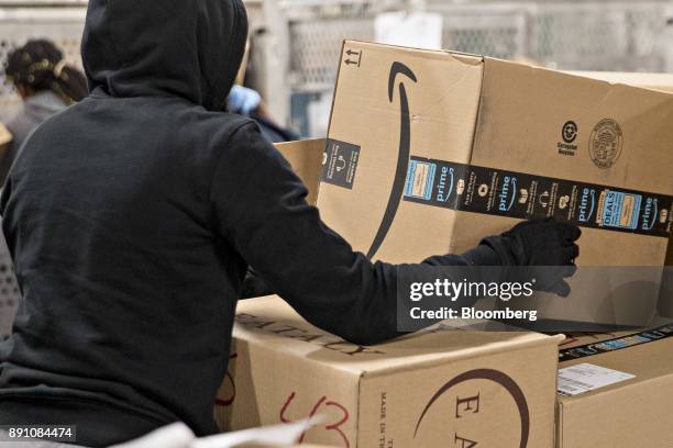 An employee moves an Amazon.com Inc. Package for delivery at the United States Postal Service Joseph Curseen Jr. And Thomas Morris Jr. Processing and...