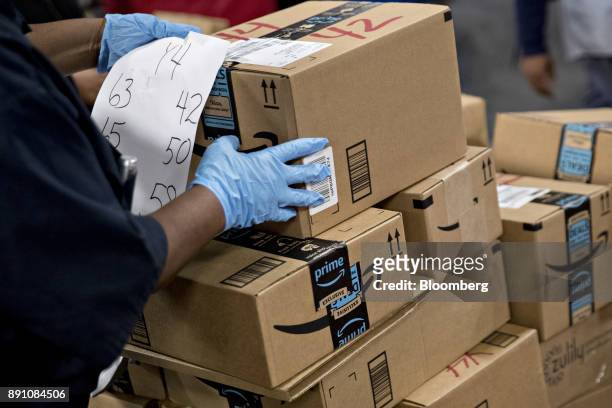 An employee arranges Amazon.com Inc. Packages before delivery at the United States Postal Service Joseph Curseen Jr. And Thomas Morris Jr. Processing...