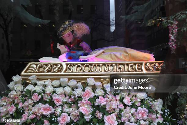 Prince kisses a sleeping Snow White at an iconic holiday window at Saks Fifth Avenue on December 12, 2017 in New York City. Security in the city...