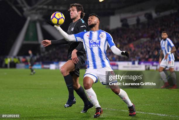 Elias Kachunga of Huddersfield Town handles the ball under pressure from Marcos Alonso of Chelsea during the Premier League match between...