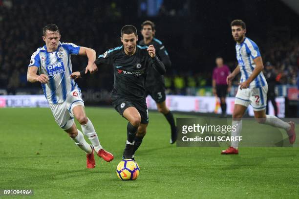Huddersfield Town's English midfielder Jonathan Hogg vies with Chelsea's Belgian midfielder Eden Hazard during the English Premier League football...