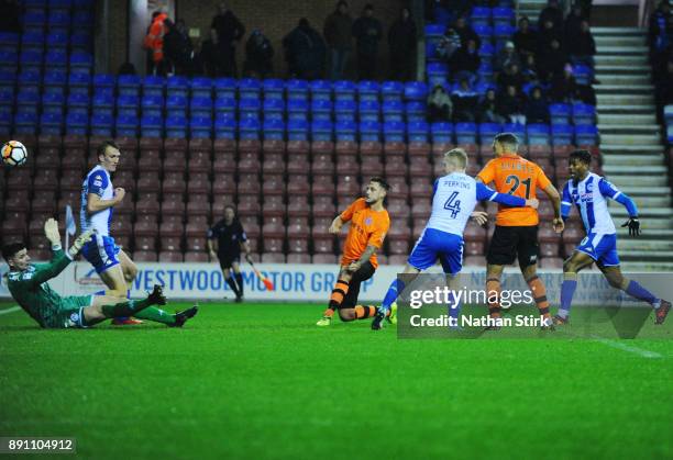 Simon Grand of AFC Fylde scores during The Emirates FA Cup Second Round Replay match between Wigan Athletic and AFC Fylde at the DW Stadium on...